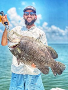 Man holding a large Tripletail