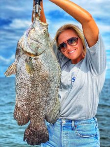 Girl holding a large Tripletail.